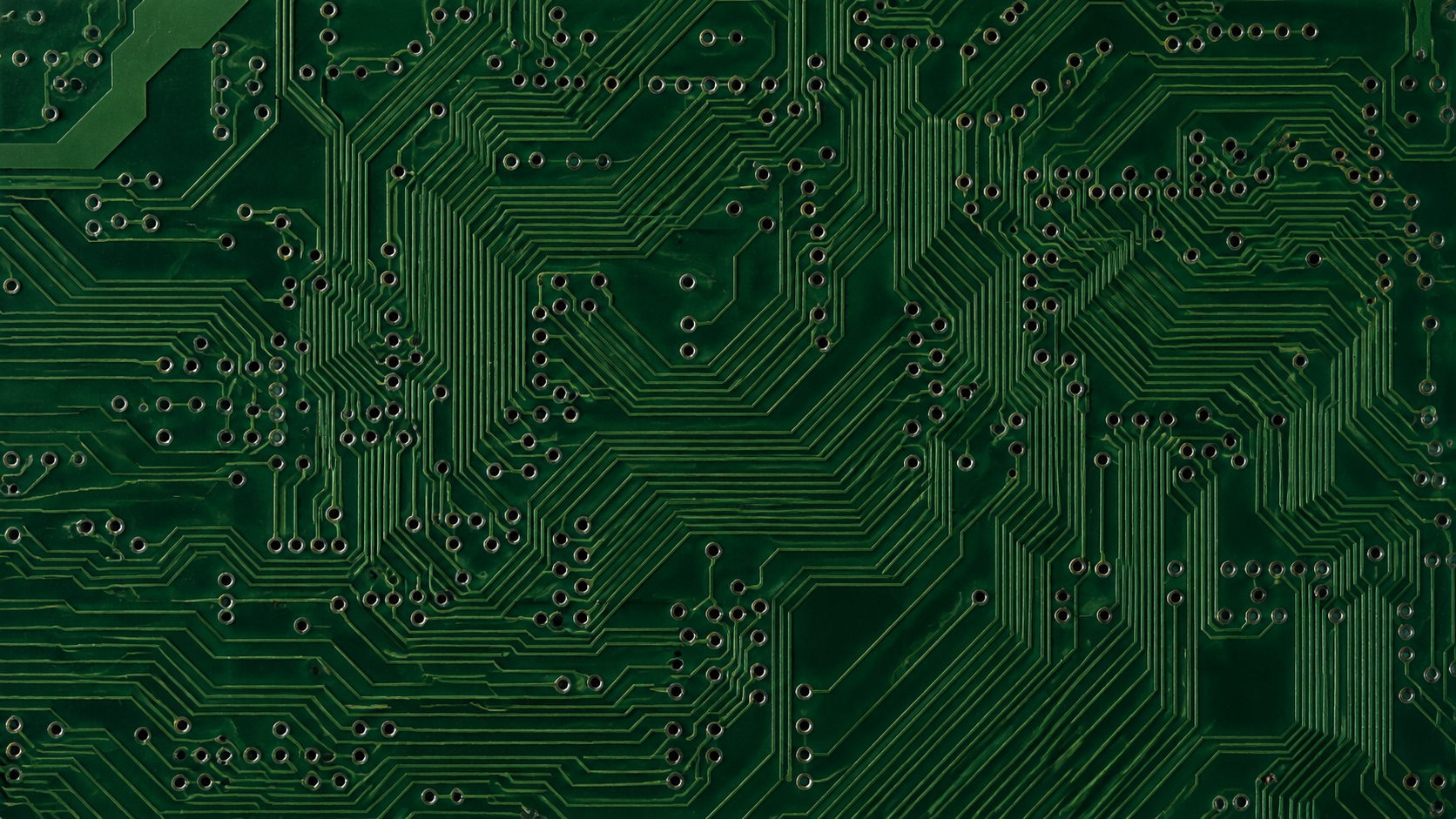 A close-up of copper traces and solder mask on a finished board